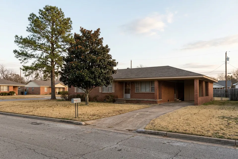 Illustration of a 1960s brick ranch house with a carport