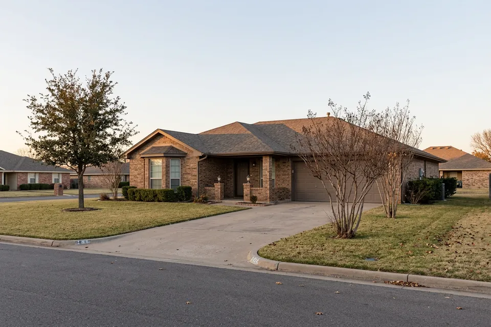 Illustration of a 1980s brown brick ranch house with a bay window