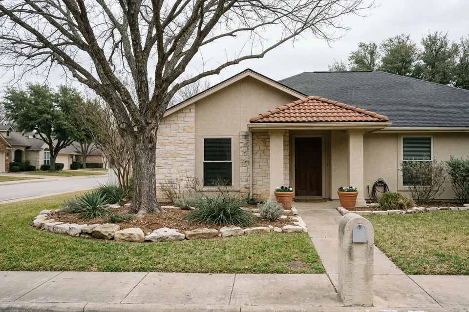Illustration of a 1990s stucco and stone house