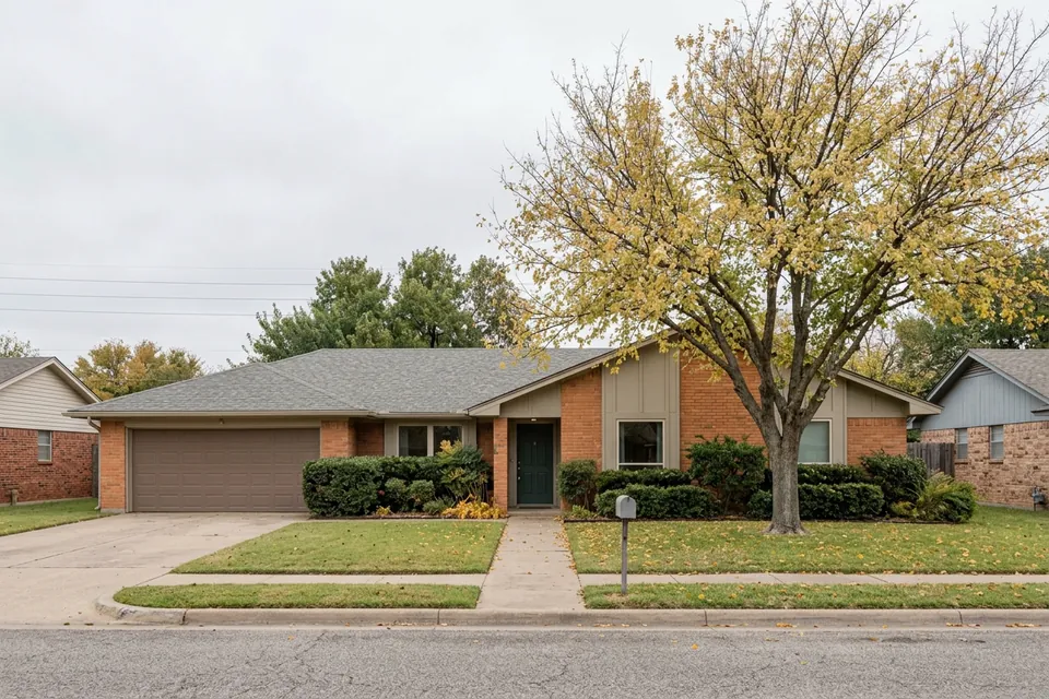 Illustration of a 1970s brick ranch house with a two-car garage