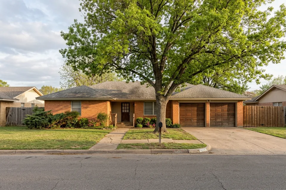 Illustration of a 1970s brick ranch house with a two-car garage