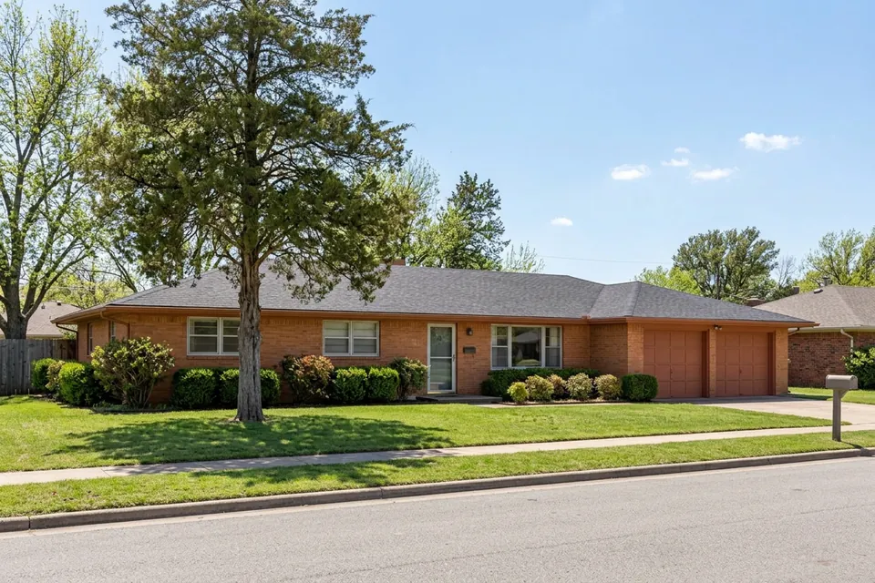 Illustration of a 1970s brick ranch house with a two-car garage