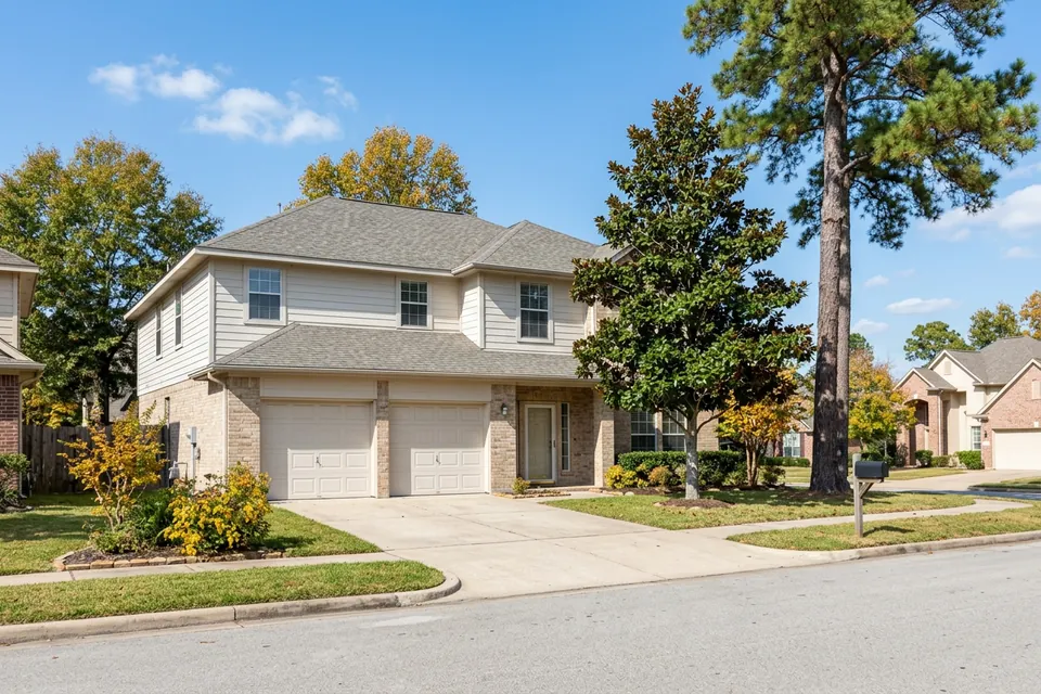 Illustration of a two-story beige brick and siding house