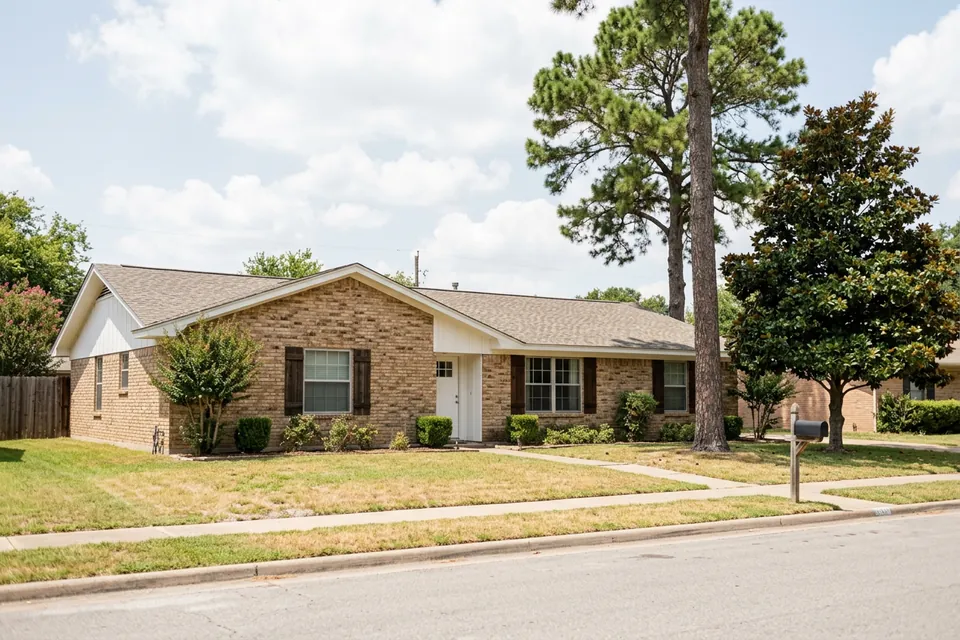 Illustration of a 1970s brick ranch house with shutters